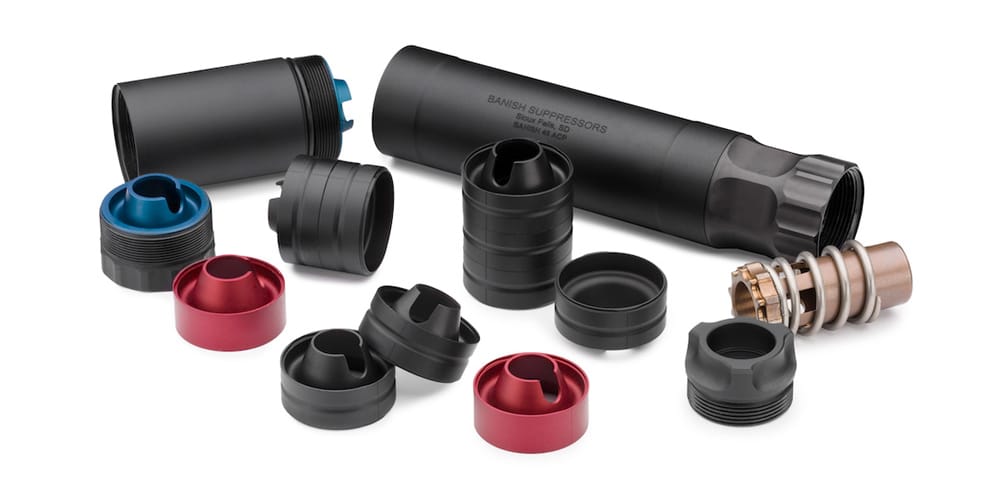 Disassembled suppressor kit on a white background: main tube, end caps in blue and red, spacers and internal parts laid out nearby.