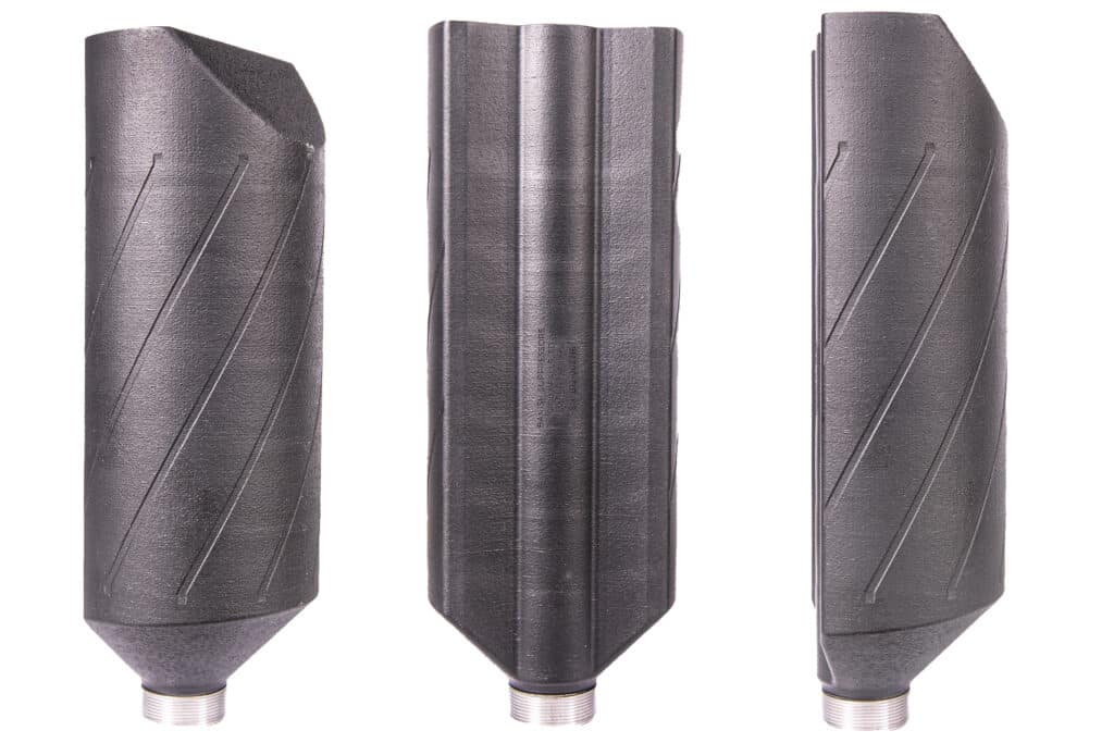 Set of three black drill bits with spiral flutes standing upright side by side on a white background