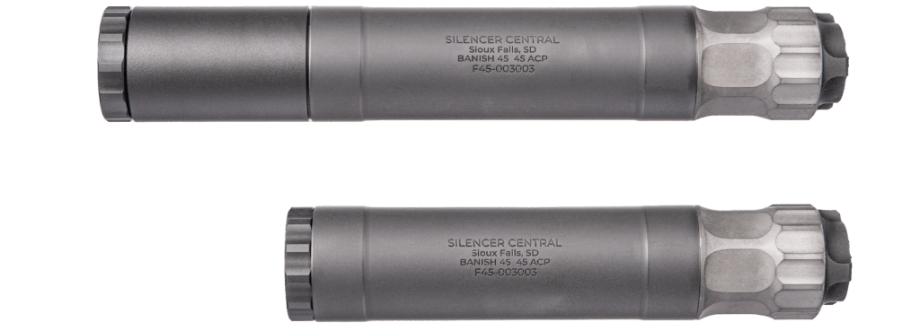 Two gray firearm silencers laid parallel on a green background, with engraved text reading Silencer Central, Sioux Falls, SD, F45-003003.
