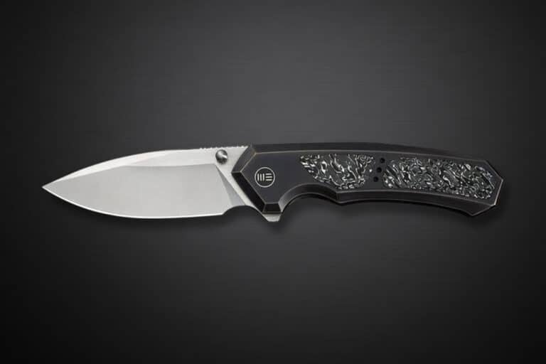 Folding pocket knife with a silver blade and a black textured handle on a dark gradient background.