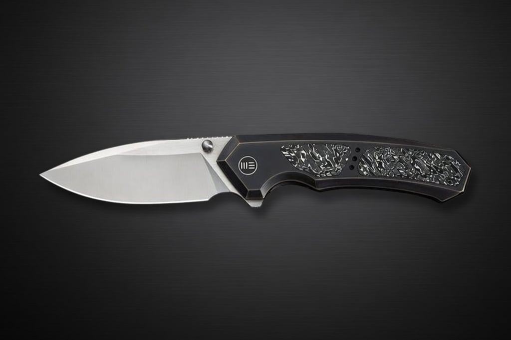 Folding pocket knife with a silver blade and a black textured handle on a dark gradient background.