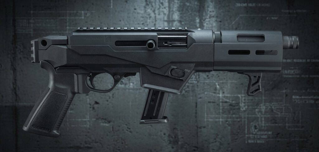 Black modern rifle with a polymer pistol grip and downward-detachable magazine on a dark industrial background.