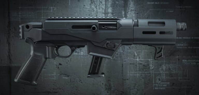 Black modern rifle with a polymer pistol grip and downward-detachable magazine on a dark industrial background.
