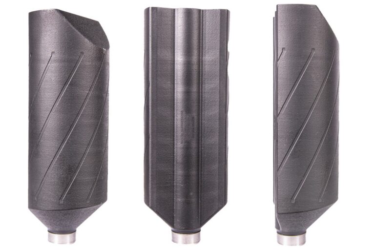 Set of three black drill bits with spiral flutes standing upright side by side on a white background