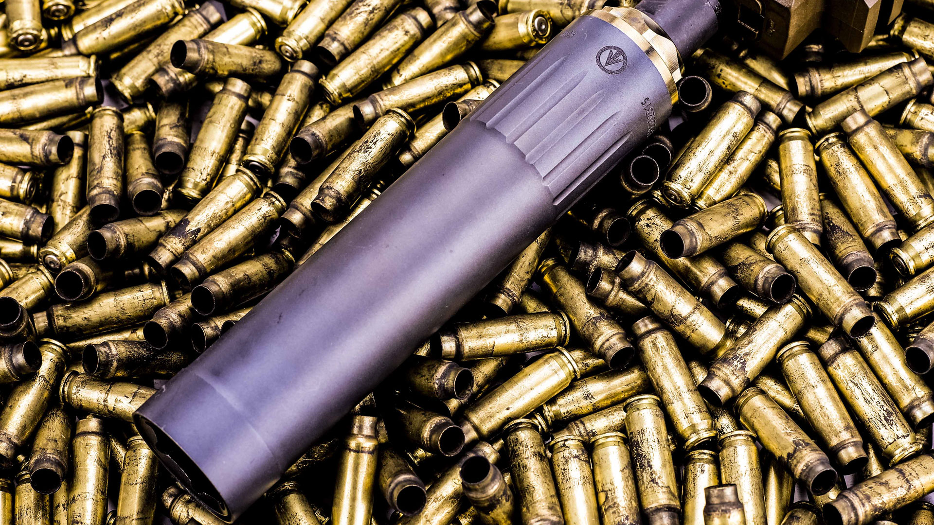 KGM RF22 rimfire suppressor on a bed of ammunition