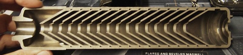 Cross section of a suppressor showing the baffles and end cap that a caliber change modifies